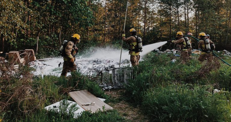 Firefighters extinguish garbage fire in homeless camp