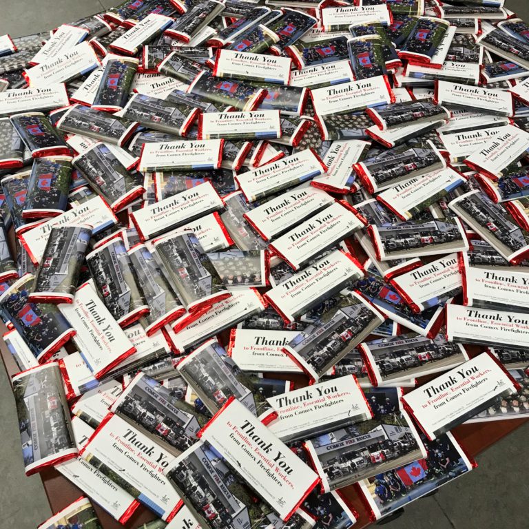 Comox firefighters delivering chocolate bars to essential workers